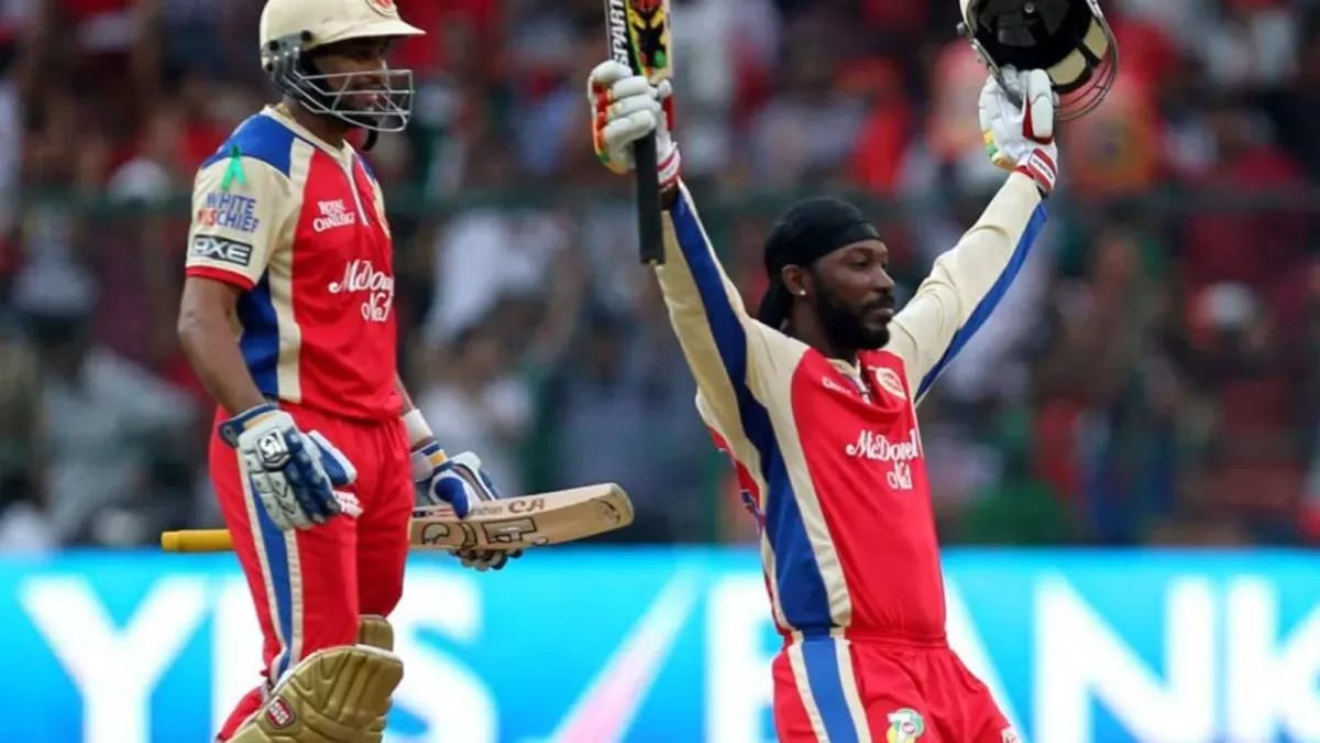 From Nightclub To Orange Cap: Chris Gayle’s 2011 RCB Twist Chris Gayle, in RCB colors alongside Virat Kohli, raises his bat after completing the century at the Chinnaswamy.