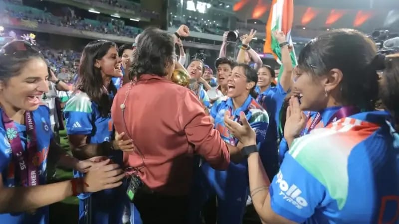 Jhulan Goswami celebrating during the Women's World Cup 2025 India's victory lap at DY Patil Stadium, with current players honoring the legends who built Indian women's cricket.