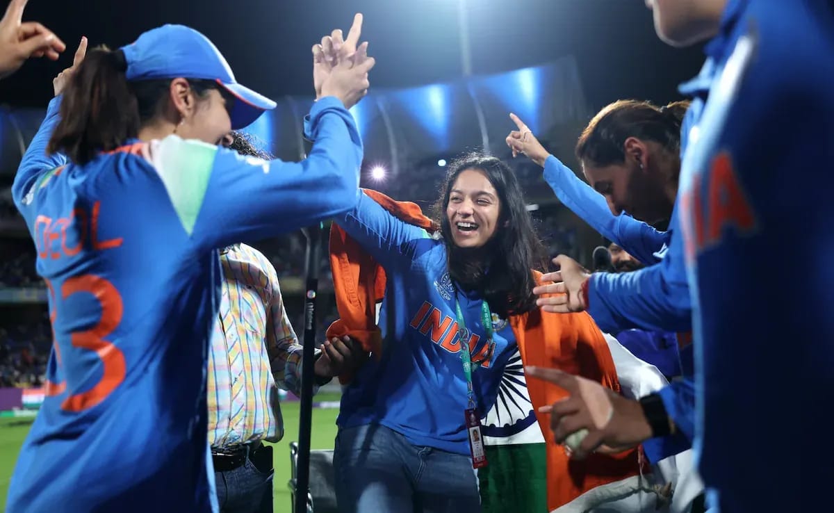 Pratika Rawal celebrating in wheelchair draped in Indian tricolour after India's Women's World Cup 2025 victory, despite missing out on winner's medal due to ICC regulations after ankle injury forced her replacement.
