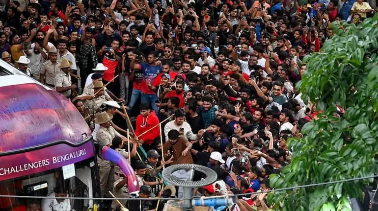 Karnataka Government Blames RCB for Bengaluru Stampede: Report Reveals Lapses After Historic IPL Win Fans rushing towards the team bus during RCB victory parade in Bengaluru later causing stampede result in deaths.