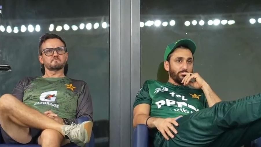 Pakistan captain Salman Ali Agha sitting alongside coach Mike Hesson outside dressing room in Dubai International stadium during match against India.