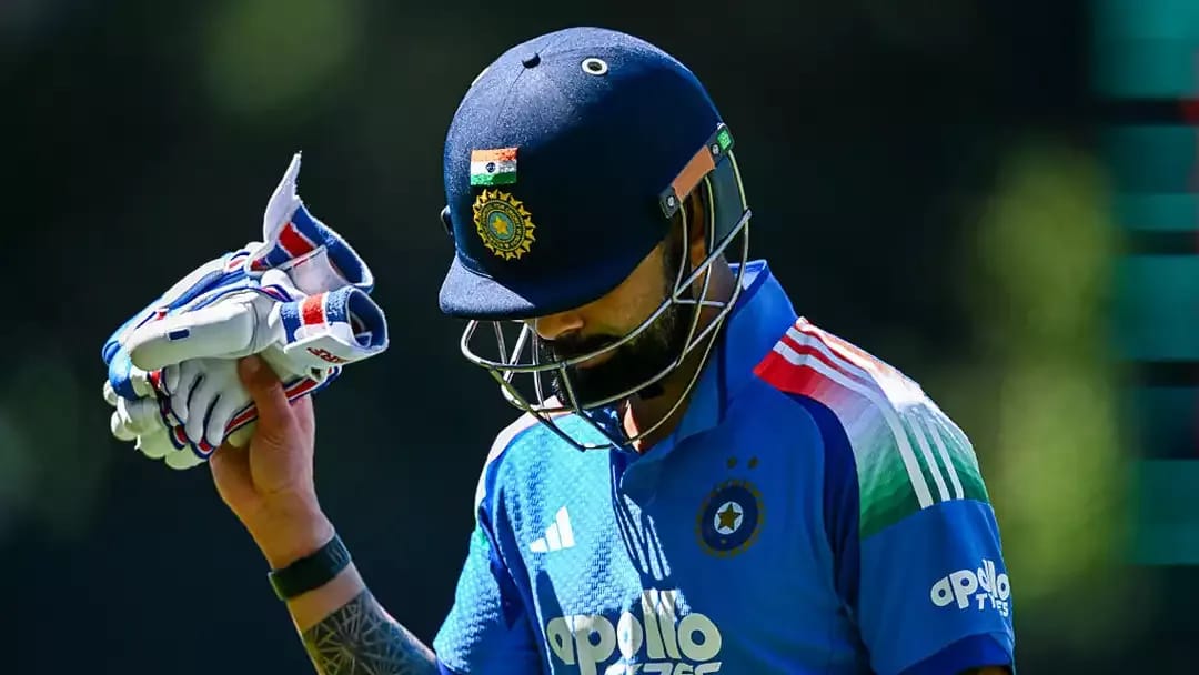 Virat Kohli raising his batting glove in acknowledgment of the Adelaide Oval crowd after consecutive ducks in the ODI against Australia, leading to retirement speculations.